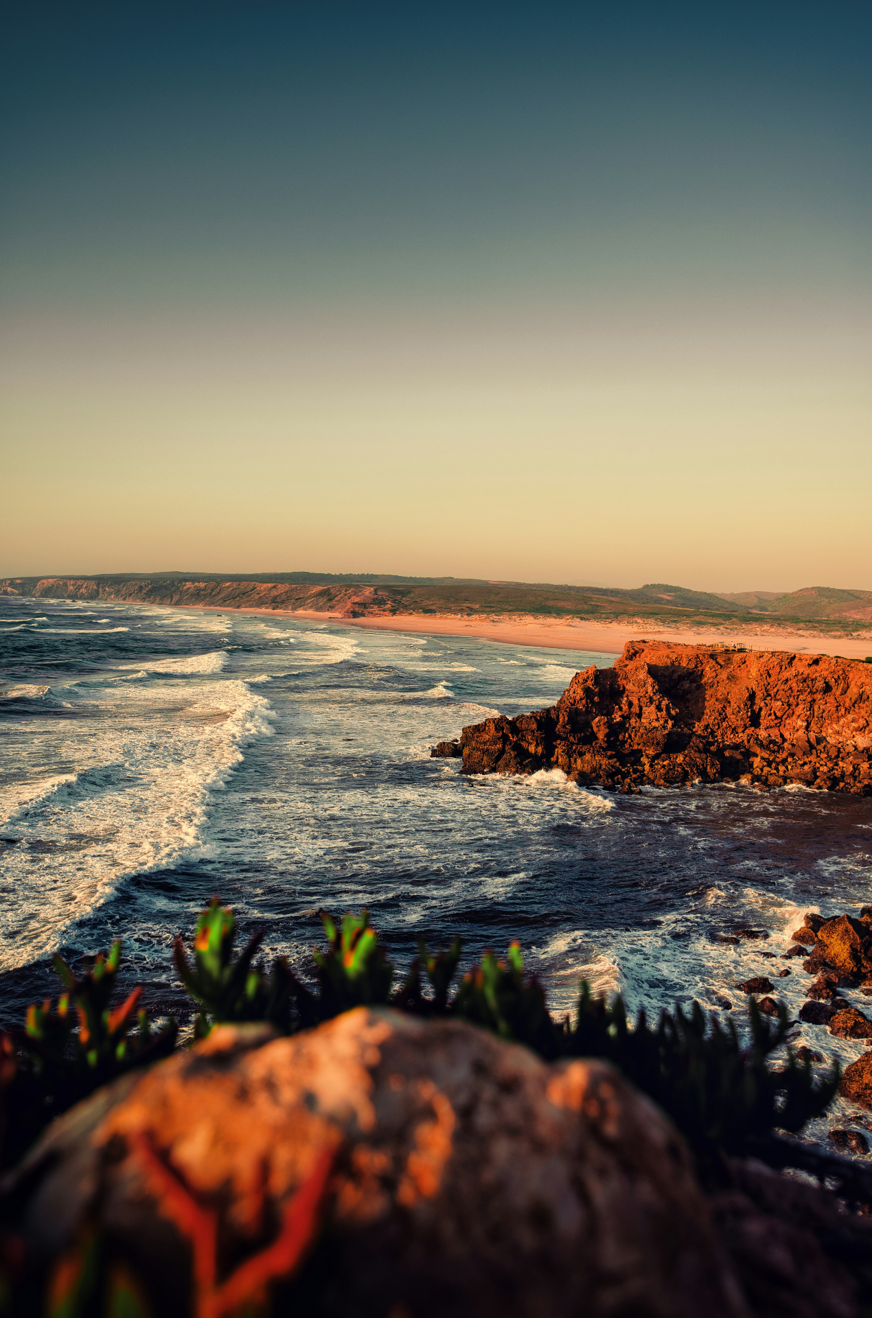 Bordeira beach waves and rocky coastline at sunset, Carrapateira Algarve