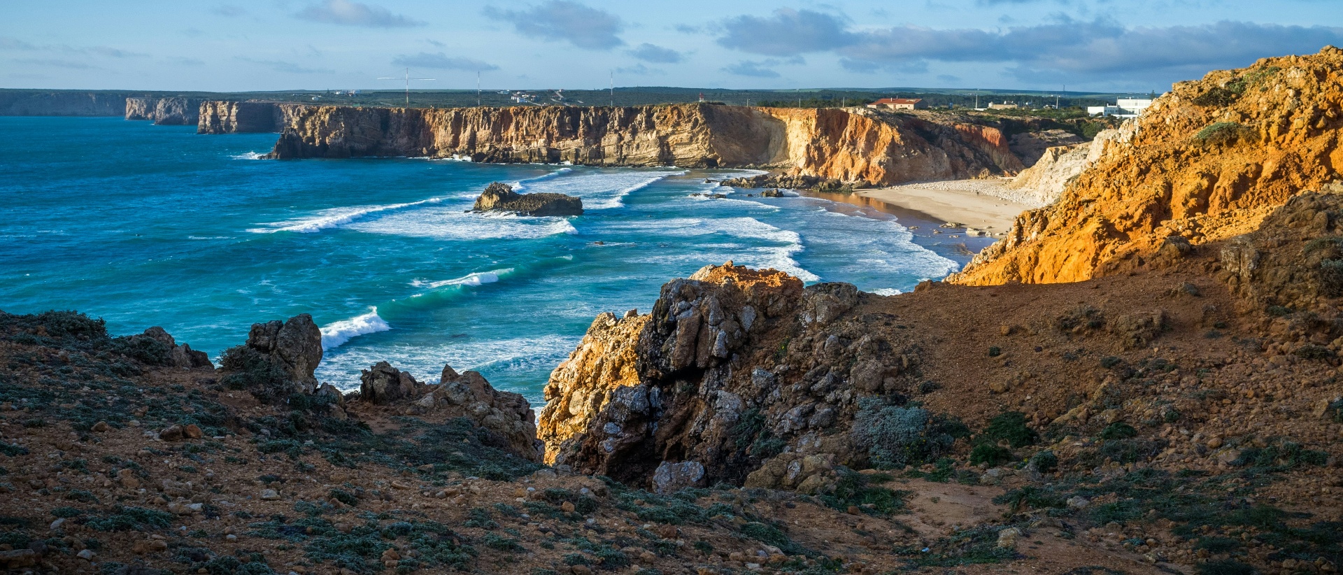 Tonel beach and dramatic Sagres cliffs with turquoise Atlantic waves, Western Algarve
